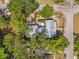 Aerial view of a charming property nestled amidst lush trees, featuring a well-manicured garden and outdoor patio at 1001 E Crawford St, Tampa, FL 33604