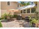 Cozy outdoor patio area with stone flooring, perfect for entertaining with a grill and dining set at 1001 E Crawford St, Tampa, FL 33604