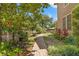 Serene backyard featuring a brick path winding through lush plants, offering a peaceful retreat at 1001 E Crawford St, Tampa, FL 33604