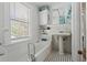 Bathroom featuring a tub, shower combo, and a pedestal sink at 1001 E Crawford St, Tampa, FL 33604