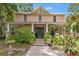 Charming two-story home with a welcoming front porch and lush landscaping at 1001 E Crawford St, Tampa, FL 33604