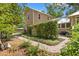 Charming home exterior with a beautiful garden, a brick pathway, and mature landscaping creating a private oasis at 1001 E Crawford St, Tampa, FL 33604
