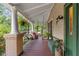 Spacious front porch ideal for outdoor living, with seating and charming details at 1001 E Crawford St, Tampa, FL 33604