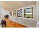 Hallway with hardwood floors, wood-paneled walls, and bright windows at 1001 E Crawford St, Tampa, FL 33604