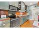 Bright kitchen features stainless steel appliances and hardwood floors at 1001 E Crawford St, Tampa, FL 33604