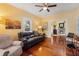 Inviting living room featuring hardwood floors, a ceiling fan, and a cozy fireplace at 1001 E Crawford St, Tampa, FL 33604