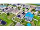 Aerial shot showing the property with white fence and neighborhood pond with mature trees and lawns at 10626 Park Meadowbrooke Dr, Riverview, FL 33578