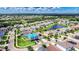 Aerial view of the property in a suburban neighborhood with a pond and mature trees at 10626 Park Meadowbrooke Dr, Riverview, FL 33578