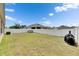 Backyard featuring grass, white fence, solar panels, an air conditioning unit, a shed and a grill at 10626 Park Meadowbrooke Dr, Riverview, FL 33578