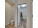 View from the bathroom with a toilet into a walk-in closet with laminate flooring and a white dresser at 10626 Park Meadowbrooke Dr, Riverview, FL 33578