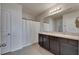 Bathroom featuring a double sink vanity, large mirror, and shower with white curtain at 10626 Park Meadowbrooke Dr, Riverview, FL 33578