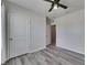 Cozy bedroom featuring a ceiling fan, wood-look floors and a bright window at 10626 Park Meadowbrooke Dr, Riverview, FL 33578