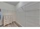 Spacious walk-in closet with laminate flooring, white dresser, and wire shelving at 10626 Park Meadowbrooke Dr, Riverview, FL 33578