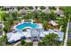 Aerial view of the community center featuring a pool, playground, and lush tropical landscaping at 10626 Park Meadowbrooke Dr, Riverview, FL 33578