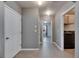 Hallway leads to laundry room with gray walls and tile flooring at 10626 Park Meadowbrooke Dr, Riverview, FL 33578