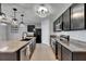 Modern kitchen featuring dark cabinets, granite counters, island sink, and stainless appliances at 10626 Park Meadowbrooke Dr, Riverview, FL 33578