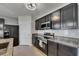 Well-equipped kitchen featuring dark cabinets, stainless steel appliances, and granite countertops at 10626 Park Meadowbrooke Dr, Riverview, FL 33578