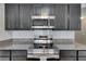 Kitchen with stainless steel appliances and stylish dark cabinetry at 10626 Park Meadowbrooke Dr, Riverview, FL 33578