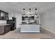 Well-appointed kitchen with island, granite countertops, stainless steel appliances, and dark cabinetry at 10626 Park Meadowbrooke Dr, Riverview, FL 33578