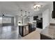 Open-concept kitchen with island, stainless steel appliances, and dark cabinetry at 10626 Park Meadowbrooke Dr, Riverview, FL 33578