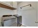 Laundry room with gray washer and dryer, upper cabinets, and bronze hardware at 10626 Park Meadowbrooke Dr, Riverview, FL 33578