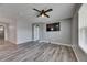 Open-concept living room featuring modern ceiling fan and wood-look flooring at 10626 Park Meadowbrooke Dr, Riverview, FL 33578