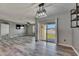 Open-concept living space with patio access, modern lighting, wood floors and living room at 10626 Park Meadowbrooke Dr, Riverview, FL 33578