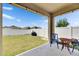 Covered patio with concrete floors, string lights, a seating set, and a view of the green backyard at 10626 Park Meadowbrooke Dr, Riverview, FL 33578
