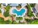 Overhead shot of the community pool, highlighting its unique shape, ample seating, and beautifully manicured surroundings at 10626 Park Meadowbrooke Dr, Riverview, FL 33578