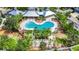 A stunning bird's eye view of a community pool surrounded by lush landscaping and comfortable lounge seating at 10626 Park Meadowbrooke Dr, Riverview, FL 33578