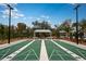 Well-maintained shuffleboard courts with shade covering and nearby park benches at 10869 Rustic Eve Ct, Land O Lakes, FL 34638