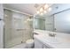 Bathroom features white vanity, glass shower and updated fixtures at 1170 Pine Ridge W Cir # C2, Tarpon Springs, FL 34688