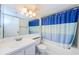 Bathroom featuring a vanity, mirror, and a shower with a blue and white curtain at 1170 Pine Ridge W Cir # C2, Tarpon Springs, FL 34688