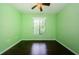 Bright bedroom featuring beautiful wood floors and a window with a view at 1170 Pine Ridge W Cir # C2, Tarpon Springs, FL 34688