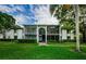 Condo building with screened balconies and lush landscaping at 1170 Pine Ridge W Cir # C2, Tarpon Springs, FL 34688