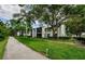 Exterior view of the well-maintained condo building surrounded by lush greenery at 1170 Pine Ridge W Cir # C2, Tarpon Springs, FL 34688