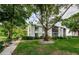Well-maintained exterior of condo building surrounded by mature trees at 1170 Pine Ridge W Cir # C2, Tarpon Springs, FL 34688