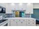 Beautiful kitchen with white cabinets, modern appliances and pass-through to living area at 1170 Pine Ridge W Cir # C2, Tarpon Springs, FL 34688