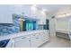 Updated kitchen with white cabinets, breakfast bar and blue tiled backsplash at 1170 Pine Ridge W Cir # C2, Tarpon Springs, FL 34688