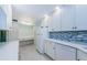 Well-lit kitchen with white cabinetry, modern appliances, work space and ample counter space at 1170 Pine Ridge W Cir # C2, Tarpon Springs, FL 34688