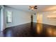 View of the living room featuring hardwood floors, a ceiling fan, and seamless flow to other rooms at 1170 Pine Ridge W Cir # C2, Tarpon Springs, FL 34688