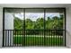 View from the screened porch highlighting the beautiful green scenery at 1170 Pine Ridge W Cir # C2, Tarpon Springs, FL 34688