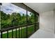Open air screened porch showcasing scenic outdoor green views and a peaceful retreat at 1170 Pine Ridge W Cir # C2, Tarpon Springs, FL 34688
