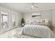 Bright bedroom features a ceiling fan, neutral decor, and access to a private balcony at 11811 Cypress Crest Cir, Tampa, FL 33626