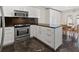 Modern kitchen with stainless steel appliances, granite countertops, and white cabinets at 11811 Cypress Crest Cir, Tampa, FL 33626