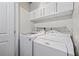 Convenient laundry area equipped with a washer, dryer, and overhead cabinets at 11811 Cypress Crest Cir, Tampa, FL 33626