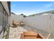 Inviting patio features neutral pavers, modern furniture, and a bright white fence for serene outdoor living at 11811 Cypress Crest Cir, Tampa, FL 33626