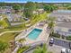 Community pool featuring lounge chairs, palm trees, and a shaded area, perfect for relaxing and enjoying the outdoors at 11811 Cypress Crest Cir, Tampa, FL 33626