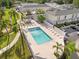 Community pool featuring lounge chairs, palm trees, and a shaded area, providing the perfect place to unwind and enjoy at 11811 Cypress Crest Cir, Tampa, FL 33626