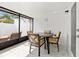 Sunroom featuring a dining table, tile floors, and large windows for natural light at 11811 Cypress Crest Cir, Tampa, FL 33626